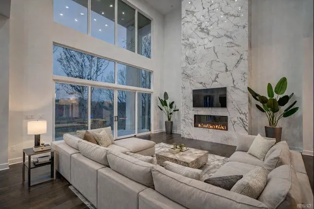 a living room with furniture tv and a fireplace