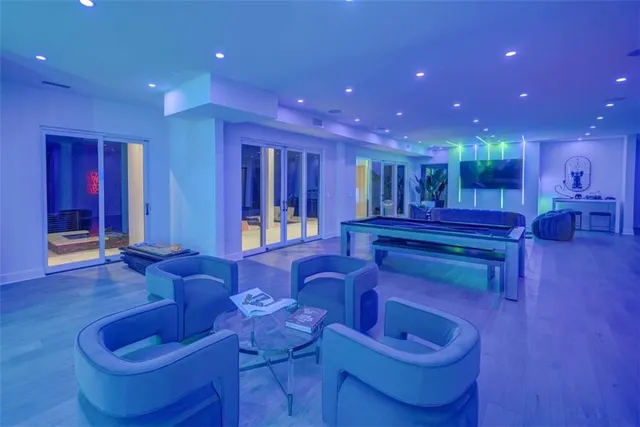 a view of a living room with kitchen countertops and wooden floor