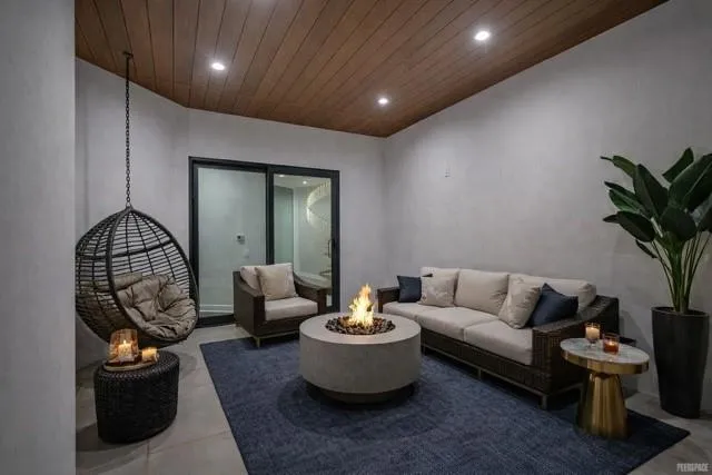 a view of backyard with swimming pool and outdoor seating