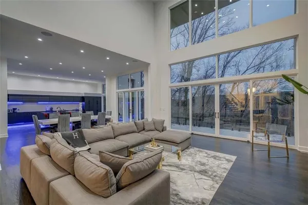 a living room with furniture and a floor to ceiling window