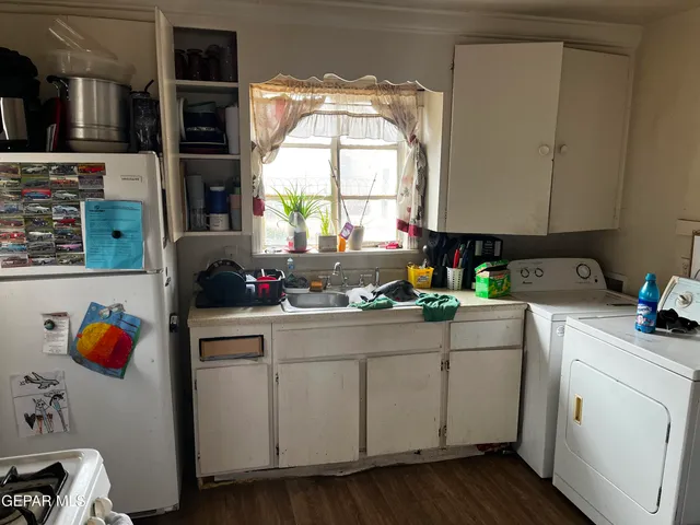 a kitchen with a sink cabinets and window