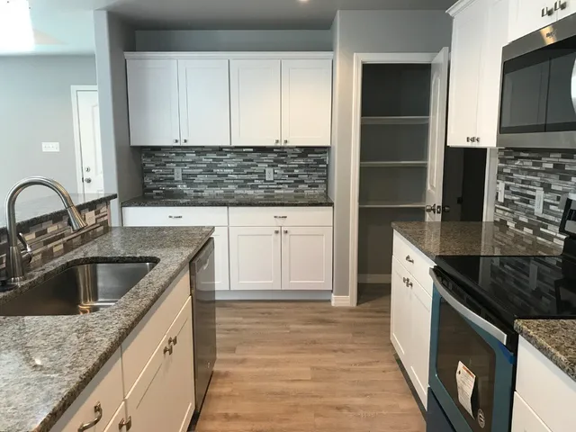 a kitchen with a sink stove and refrigerator