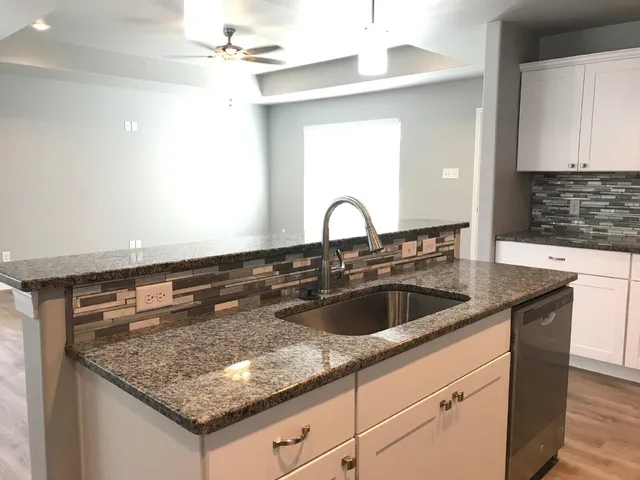 a kitchen with a granite countertop sink
