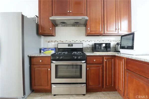 a kitchen with stainless steel appliances granite countertop a stove and a refrigerator