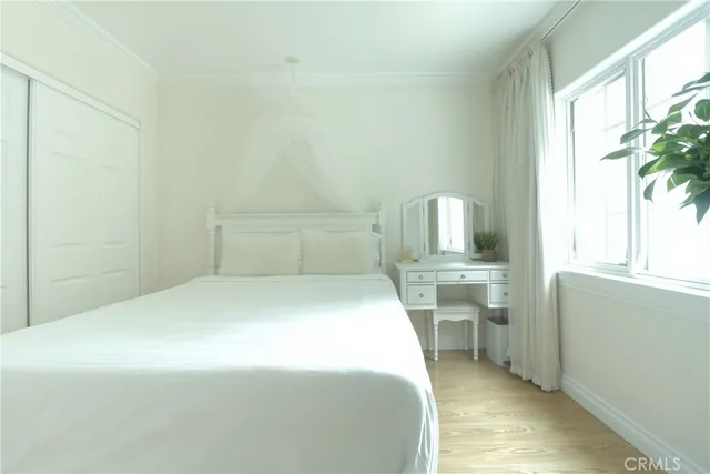 a bedroom with a bed and a potted plant