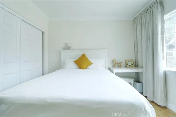 a bedroom with a large bed and a chandelier