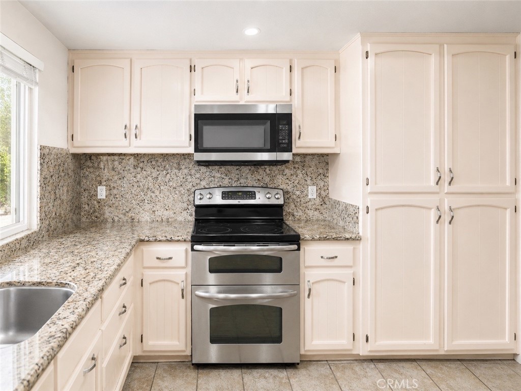 4100 Ahwahnee Court Modesto, CA 95356 - Photo 11 of 34 Updated kitchen with granite counters, stainless appliances, and ample cabinetry.