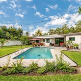 a front view of house with yard and green space