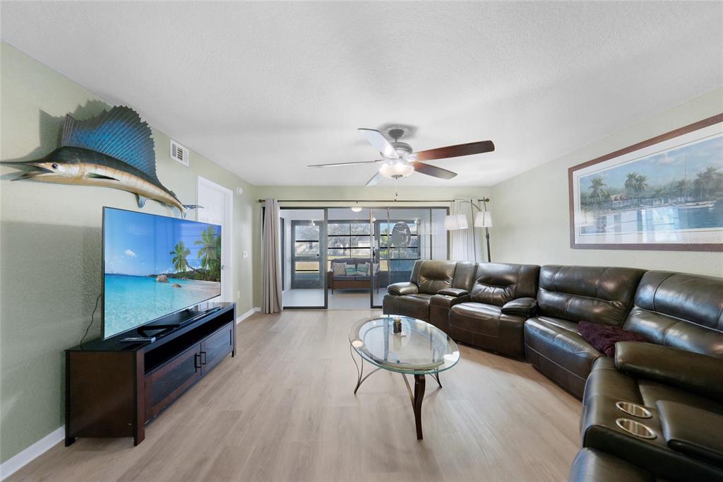 240 Lewis Circle, Unit 513 Punta Gorda, FL 33950 - Photo 14 of 45 a living room with furniture and a flat screen tv