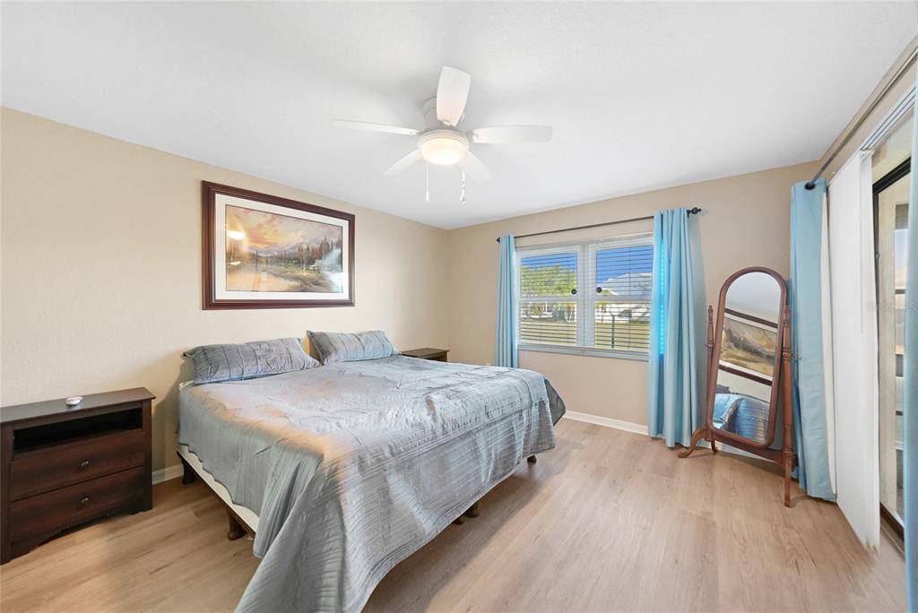 240 Lewis Circle, Unit 513 Punta Gorda, FL 33950 - Photo 15 of 45 a bedroom with a bed and a dresser