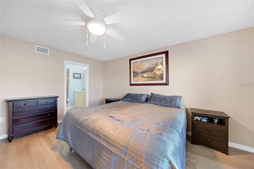 240 Lewis Circle, Unit 513 Punta Gorda, FL 33950 - Photo 16 of 45 a bedroom with a bed and a dresser