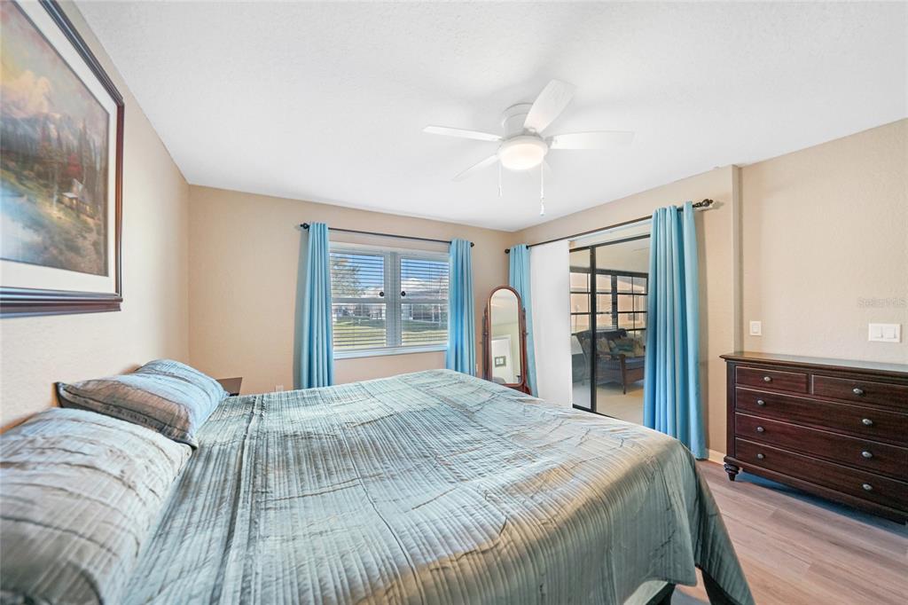 240 Lewis Circle, Unit 513 Punta Gorda, FL 33950 - Photo 17 of 45 a bedroom with a bed and wooden floor