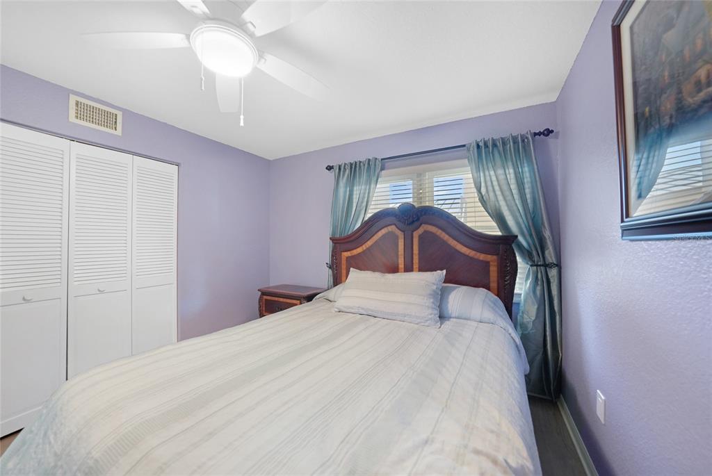 240 Lewis Circle, Unit 513 Punta Gorda, FL 33950 - Photo 22 of 45 a bedroom with a bed and a chandelier
