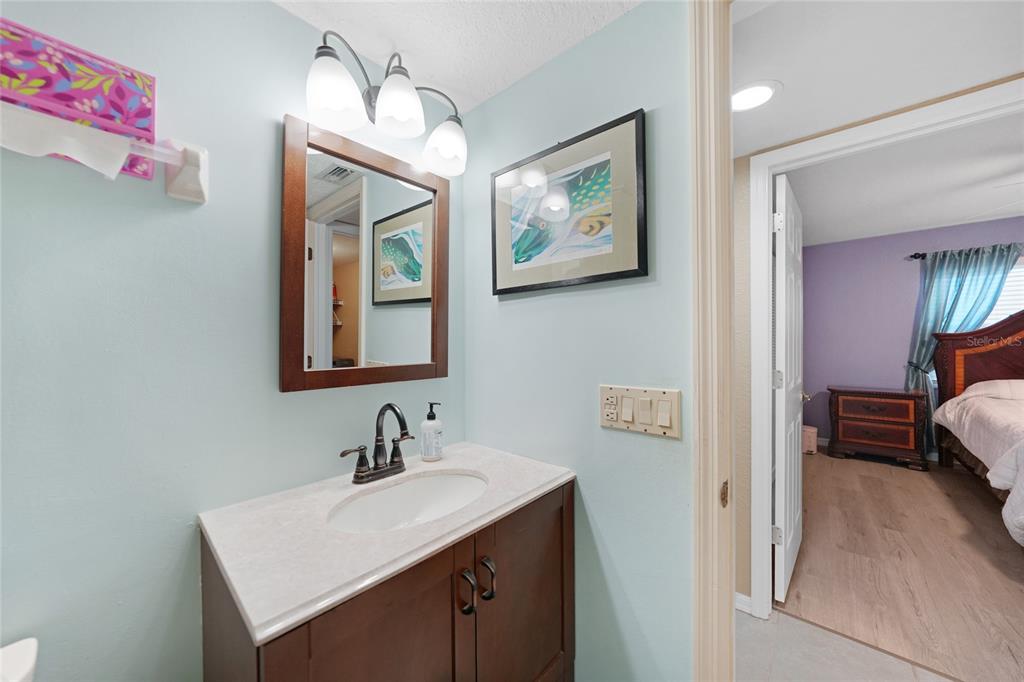 240 Lewis Circle, Unit 513 Punta Gorda, FL 33950 - Photo 23 of 45 a bathroom with a sink and a mirror