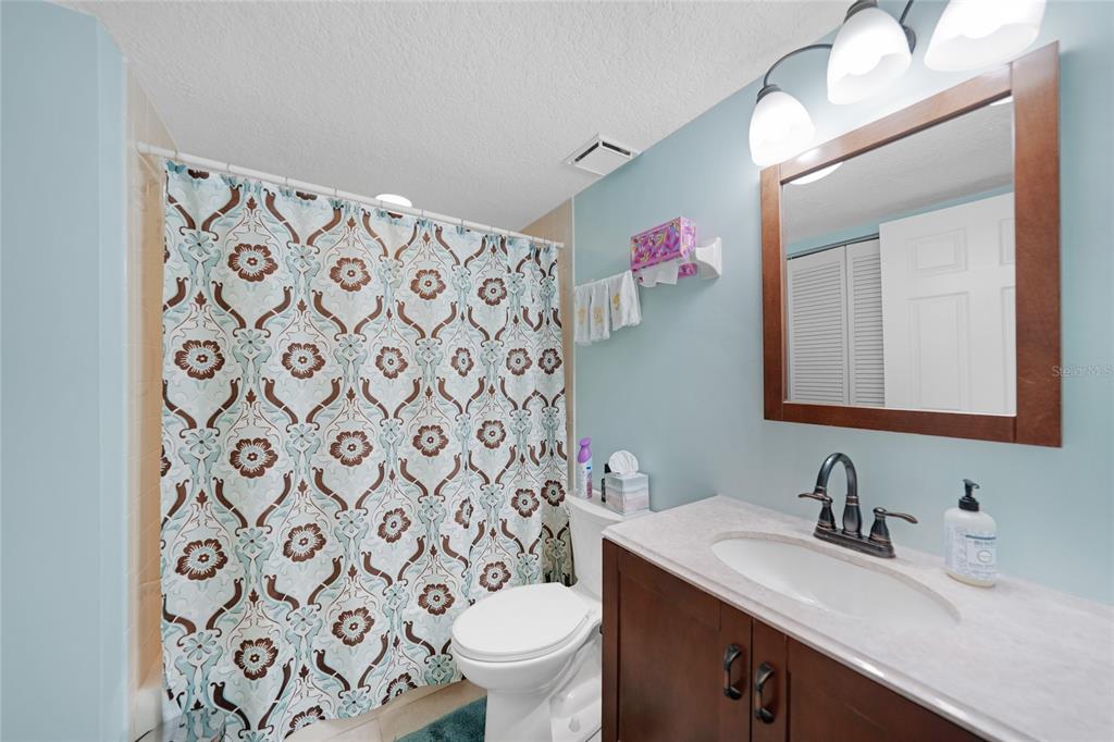 240 Lewis Circle, Unit 513 Punta Gorda, FL 33950 - Photo 24 of 45 a bathroom with a granite countertop sink mirror and toilet