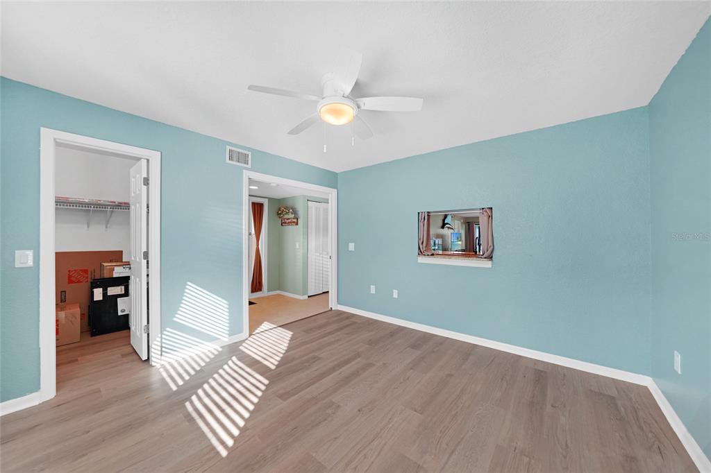 240 Lewis Circle, Unit 513 Punta Gorda, FL 33950 - Photo 26 of 45 a view of a livingroom with wooden floor and a ceiling fan