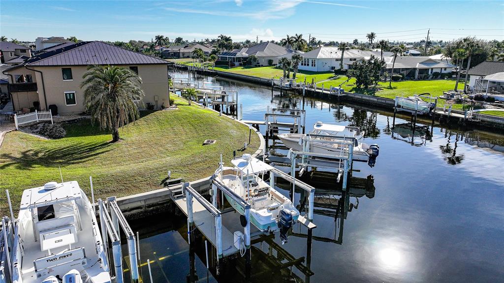 240 Lewis Circle, Unit 513 Punta Gorda, FL 33950 - Photo 34 of 45 a view of a swimming pool with a table and chairs under an umbrella