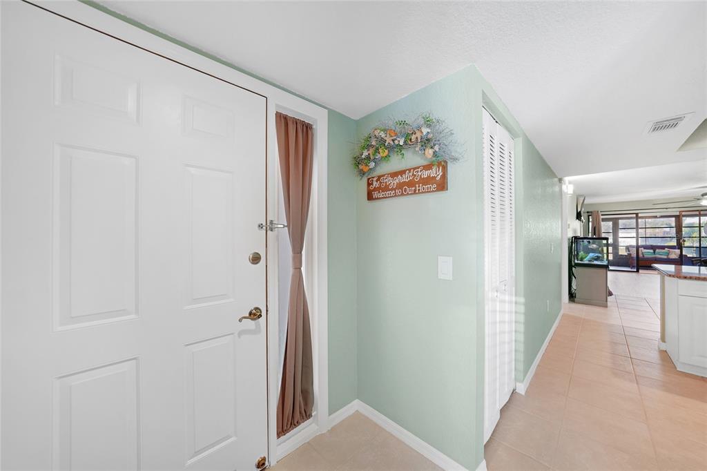 240 Lewis Circle, Unit 513 Punta Gorda, FL 33950 - Photo 6 of 45 a view of a hallway with wooden shelves