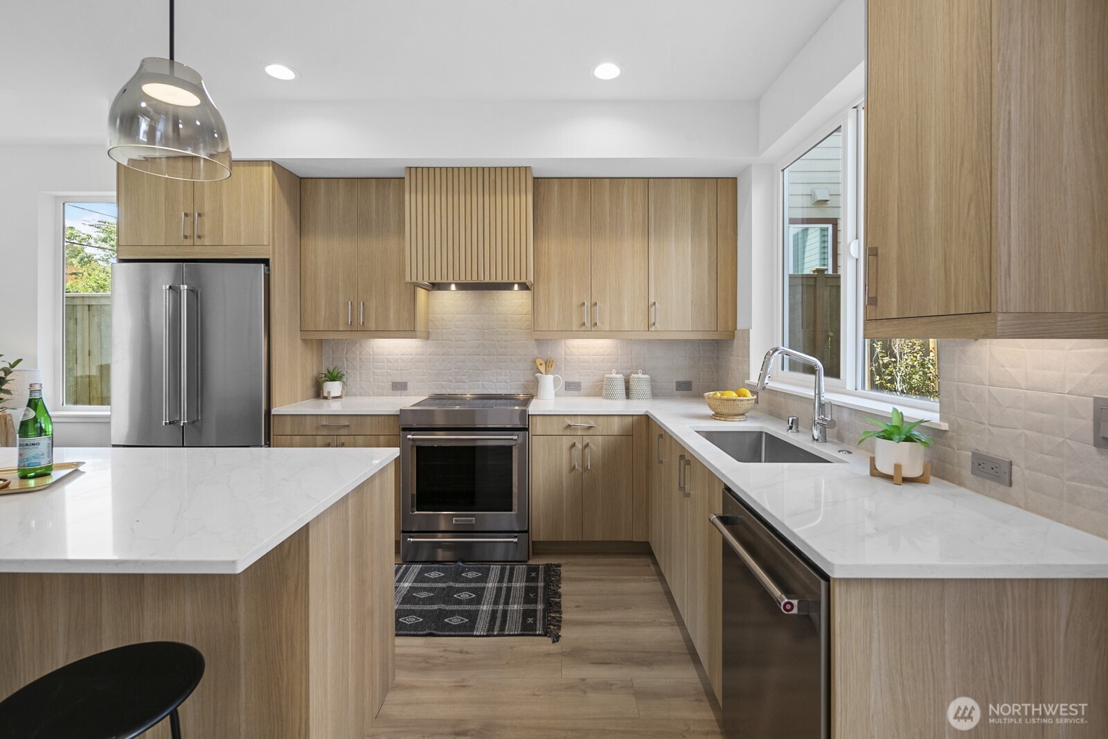 1748 Northwest 62nd Street Seattle, WA 98107 - Photo 4 of 33 a kitchen with stainless steel appliances granite countertop a sink stove and refrigerator