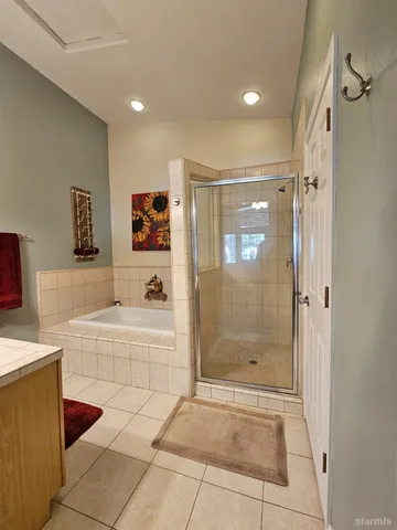 a bathroom with a bathtub and a shower