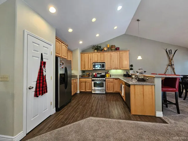 a kitchen with a refrigerator a sink and a stove