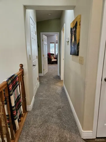 a view of a hallway view with wooden floor and stairs