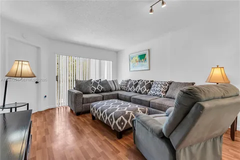 a living room with a couch and a window