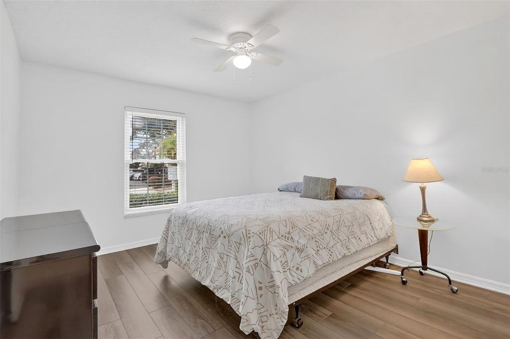 600 Northern Way, Unit 303 Winter Springs, FL 32708 - Photo 15 of 25 a bedroom with a bed and a lamp on table