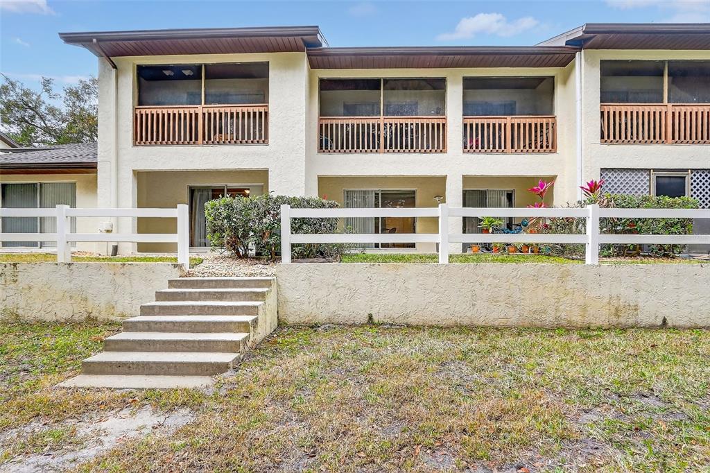 600 Northern Way, Unit 303 Winter Springs, FL 32708 - Photo 18 of 25 a front view of a house with a yard