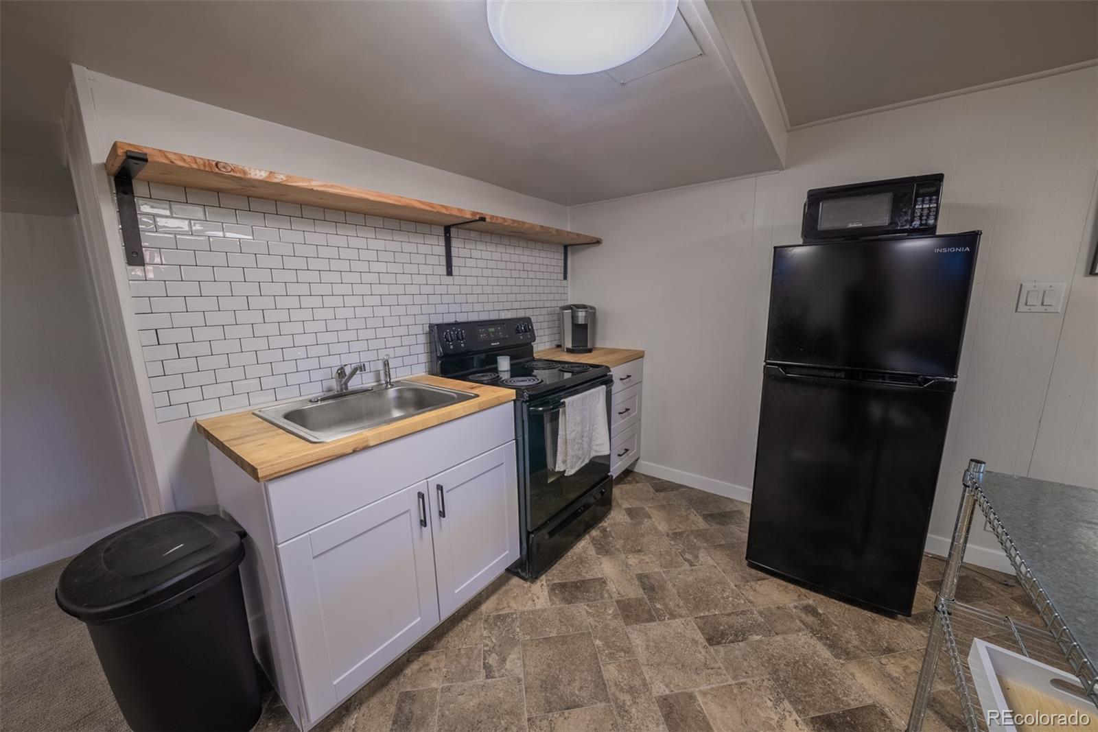 4947 South Perry Street Littleton, CO 80123 - Photo 15 of 24 a kitchen with a refrigerator and a stove
