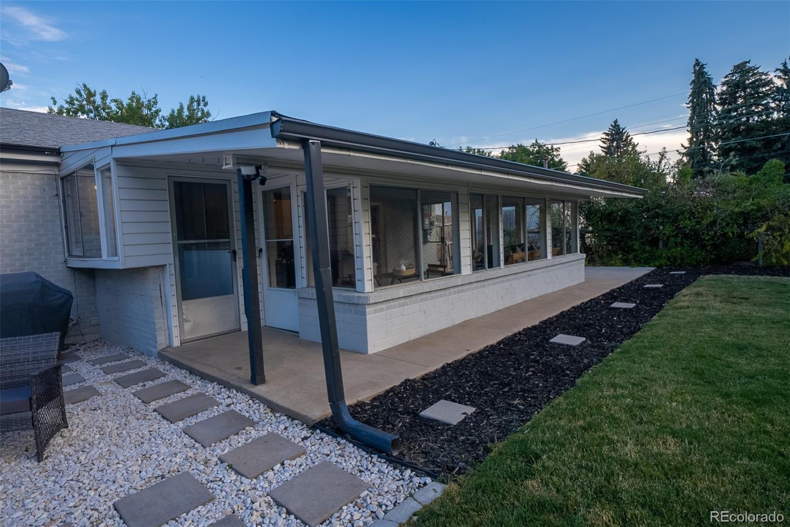 4947 South Perry Street Littleton, CO 80123 - Photo 21 of 24 a view of a house with yard and sitting area