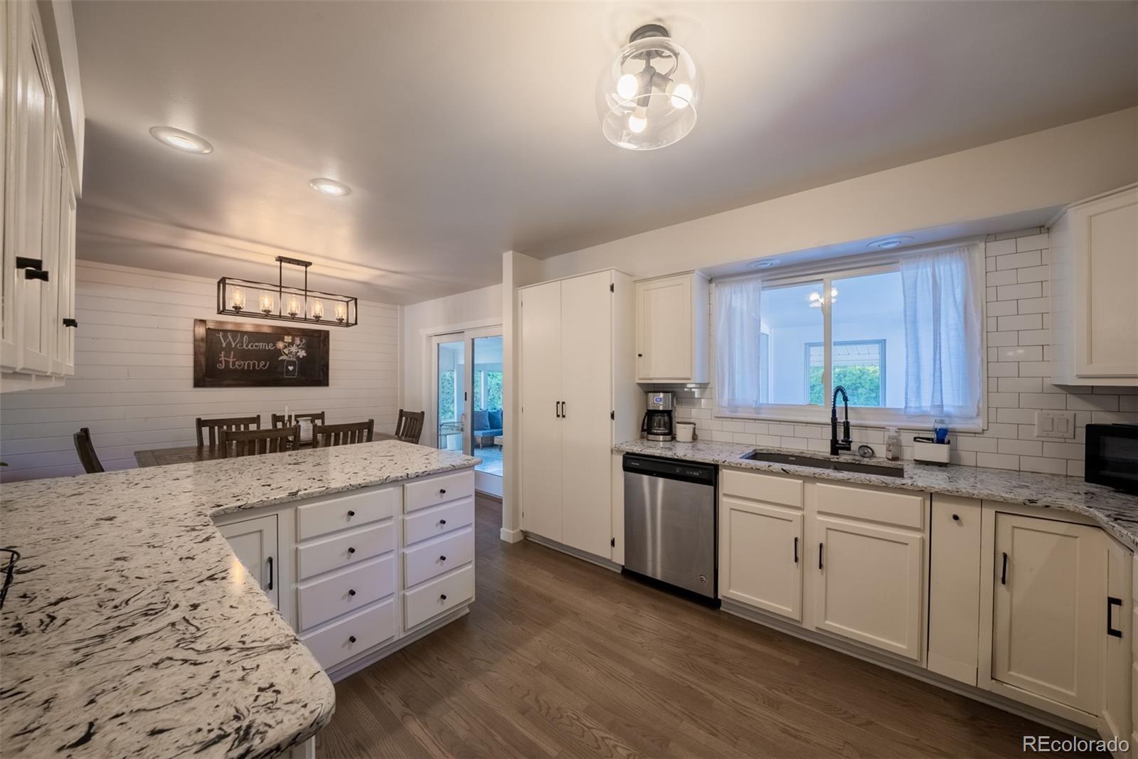 4947 South Perry Street Littleton, CO 80123 - Photo 6 of 24 a kitchen with a sink stove and cabinets