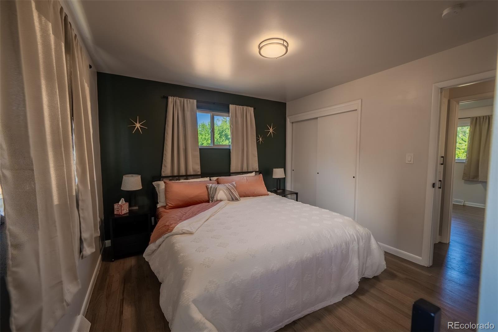 4947 South Perry Street Littleton, CO 80123 - Photo 7 of 24 a bedroom with a bed and a window