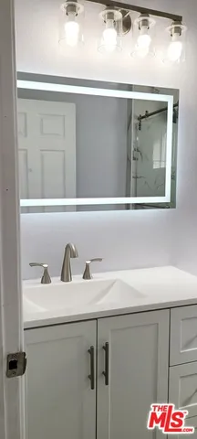 a bathroom with a glass shower door and a bathtub