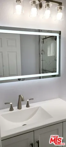 a bathroom with a glass shower door