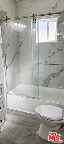 a bathroom with a shower and a shower