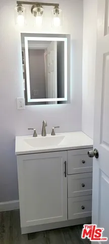 a white toilet sitting next to a bathroom sink