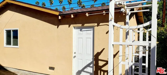 a view of a house with a tree