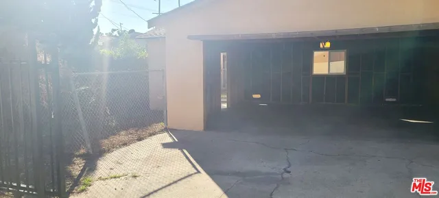 a view of a house with wooden fence