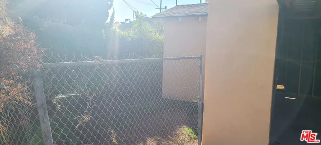 a view of a pathway of a house with wooden wall