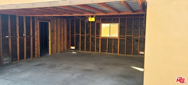 a view of a pathway along a house with wooden floor