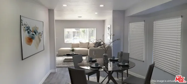 a living room with furniture and large windows