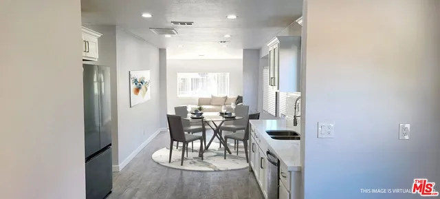a view of a dining room with furniture and a chandelier