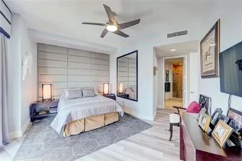 a bedroom with a bed and wooden floor