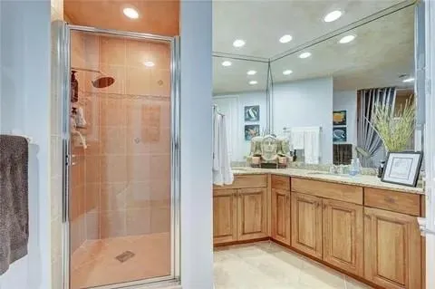 a bathroom with a shower sink and mirror