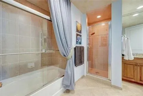 a bathroom with a bathtub and a shower