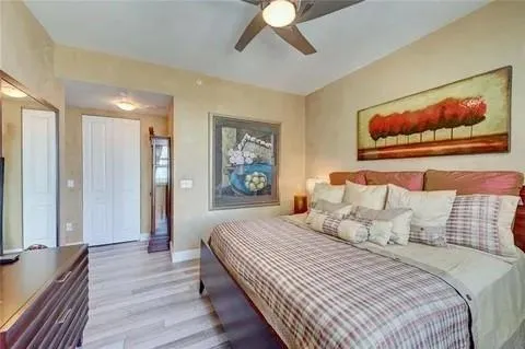 a bedroom with bed and wooden floor