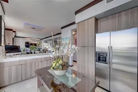 a kitchen with refrigerator and cabinets