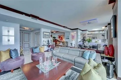 a living room with furniture and a dining table