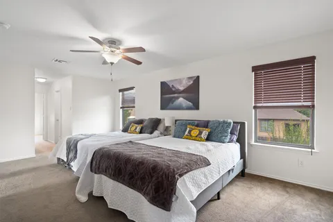 a bedroom with a bed and a window